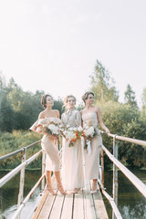 Beautiful bride in front of wedding arch with flowers and decor. Bouquet in the hands and details....