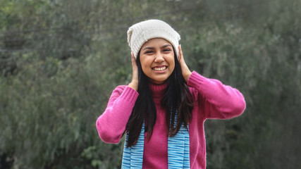 Cute Peruvian Female And Confusion Wearing Pink Sweater
