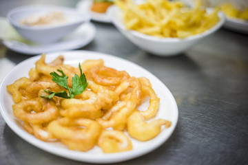Squids fried in deep oil on white plate © malajscy