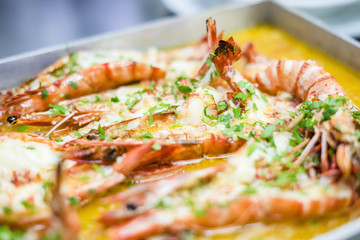 Baked tiger shrimps in a butter sauce with herbs