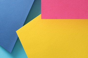 paper layers. abstract geometric background with copy space. yellow blue and pink color shades.