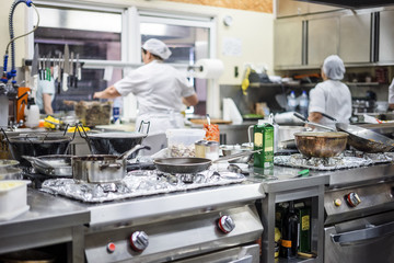 Kitchen staff busy with preparing food in fancy restaurant