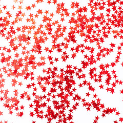 small red stars scattered on a white background