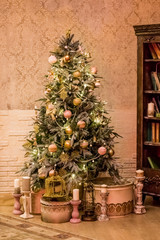 Christmas decor of a retro stylish living room with a vintage furniture, Christmas tree and candles.Merry Christmas and Happy Holidays. A beautiful living room decorated for Christmas.Calm image of
