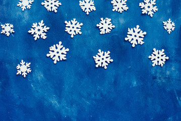 white snowflakes homemade on blue background, winter, place for text