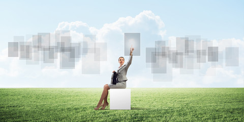 Attractive business lady or accountant outdoors on white box