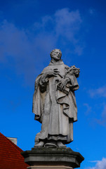 Fototapeta na wymiar Czech, Prague, gothic sculpture of the of Philip Benizi de Damiani on the Charles bridge. Prague, medieval art, statue of Saint on the bridge of King Charles.