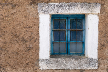 Old blue wooden window frame with grille