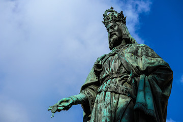 Statue of King Charles, Prague, on a blue sky background. Monument sculpture of the Czech King Charles 4