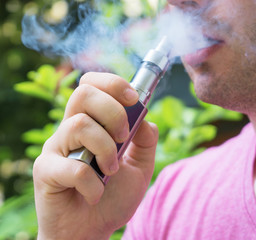 Man smoking an electronic cigarette. Close-up view.