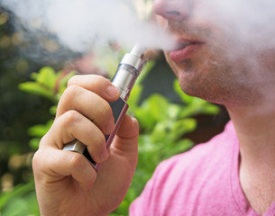 Man smoking an electronic cigarette. Close-up view.
