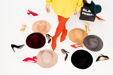 partial view of woman, female shoes, hats and shopping bags with black friday inscription isolated...