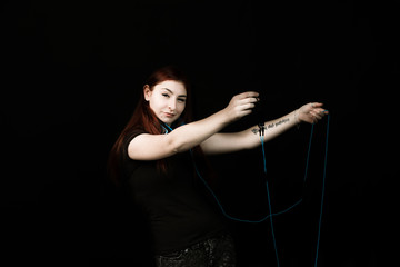 young Redhead woman with blue headphones dancing