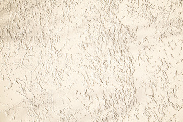 Beige facade plaster background. Monolayer glued wall from cement plaster. The appearance of the structure of the building. Silicate sand Cement plaster. Copy space