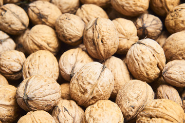 Walnut background, scattered pile of walnuts