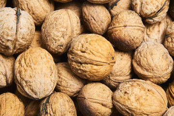 Walnut background, scattered pile of walnuts