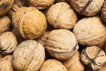 Walnut background, scattered pile of walnuts