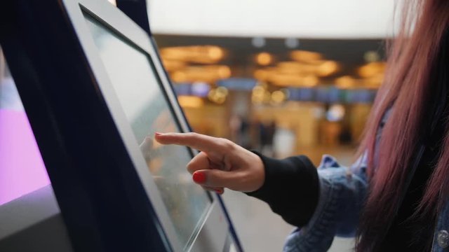 Young Mixed Raced Woman Touching Self Check In Desk Screen Terminal in Airport. 4K.