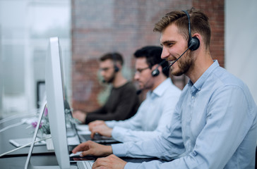 employees with a headset in the workplace in the business center