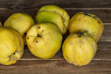 Apple quince. juicy ripe fragrant yellow quince on a wooden table