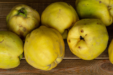 Apple quince. juicy ripe fragrant yellow quince on a wooden table