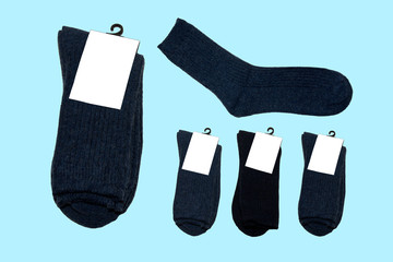 five pairs of new warm socks on blue background