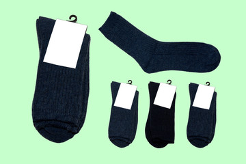 five pairs of new warm socks on green background