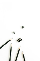 Pencils and sharpener on white background. Flat lay, top view study concept.
