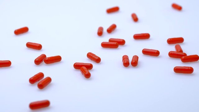 The concept of medicine. A pile of pills falls on white table. Pharmaceutical preparations. Vitamins.
