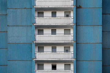 View of the old blue panel house with balconies.