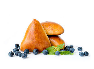 Homemade yeast dough pies with blueberry and blueberry berries on white background
