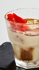 Tiramisu in glass, traditional coffee flavored Italian dessert made of ladyfingers and mascarpone.