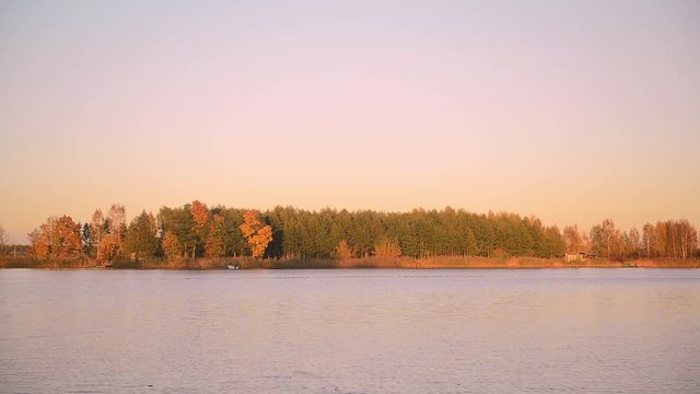 Autumn river landscape on a calm, clear, windless day at sunset.