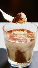 Tiramisu in glass, traditional coffee flavored Italian dessert made of ladyfingers and mascarpone.