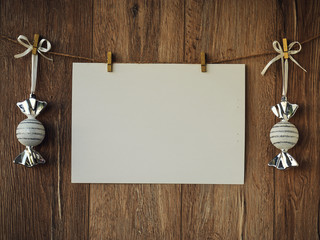 Christmas decorations on a wooden background. Vintage greeting card. New Year decorations and free space for text on a wooden background. Holidays decor on the clothespins. Vintage texture. Copy space