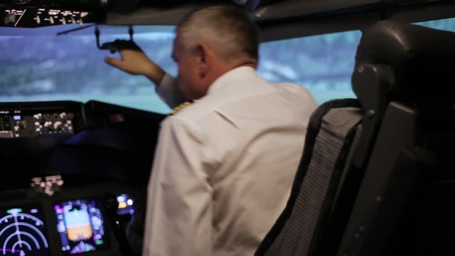 The pilot is preparing to fly in the cabin of a passenger plane