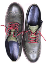 A pair of khaki color oxford man shoes with red shoelaced on white  background. Fashion footwear. Brogues. Burgundy color