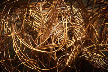 Crumpled copper wire on an old wooden board. Selective focus