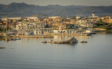 Fototapeta na wymiar Olbia in Sardinia. Landscape around Olbia, view from cruise ship arriving into the Olbia harbor in Sardinia island, morning scene