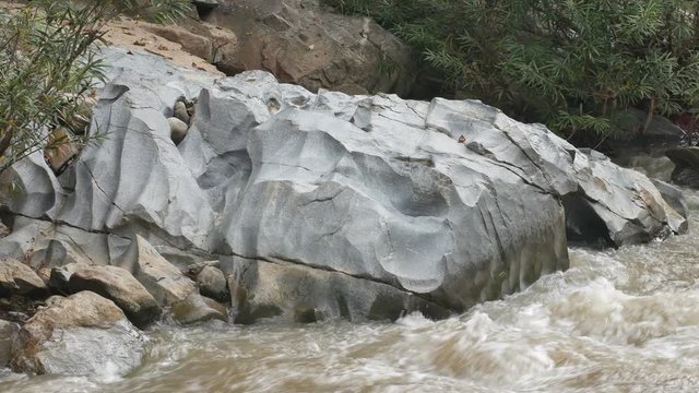 water flow in the rocky stream with beautiful weathering rock at Ob Khan National Park, Thailand