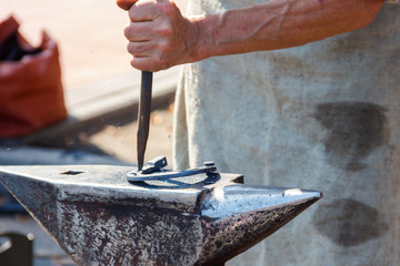Blacksmith forging a horseshoe close-up