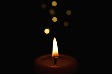 Candles Burning at Night. White Candles Burning in the Dark with focus on single candle in foreground. 