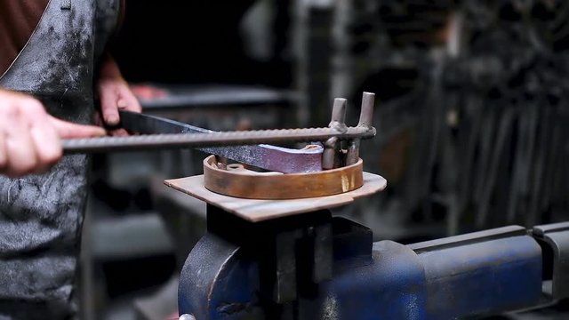 Blacksmith shaping the molten metal 4k