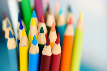 Multicolored pencils on wooden background. Many beautiful multicolored pencils on the table. Pencils for coloring, Creativity.