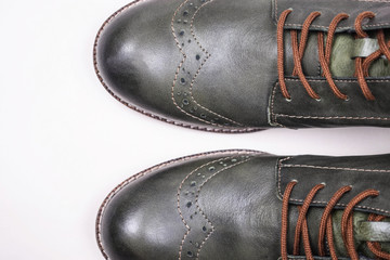 A pair of khaki color oxford man shoes with red shoelaced on white  background. Fashion footwear. Brogues. Burgundy color