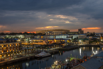 Fototapeta na wymiar Cape Town - sunset colors in south Africa - water front - from a roof top - magical landscape overlooking city's stadium and water canal 
