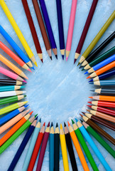 Multicolored pencils on wooden background. Many beautiful multicolored pencils on the table. Pencils for coloring, Creativity.