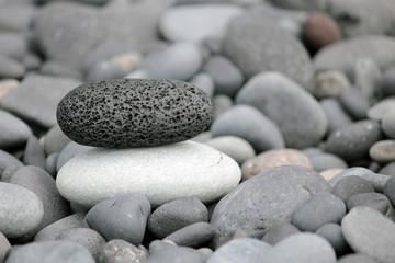 Fototapeta na wymiar Black stone on white stone. Balanced stones.