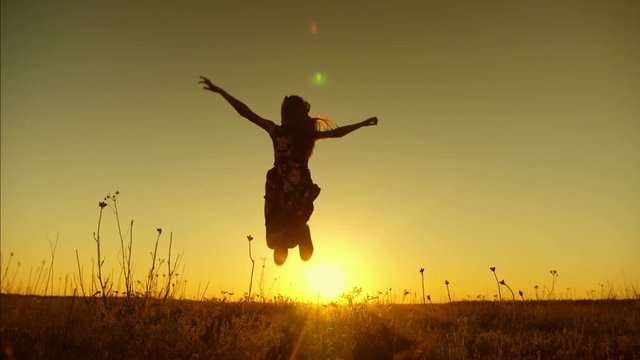 Happy Girl With Long Hair Jumps At Sunset Of Sun. Slow Motion.