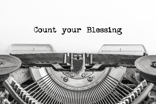 Count your Blessing, the text is typed on a vintage typewriter, in black ink on old paper. close-up